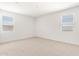 A bright bedroom with carpeted floors and two windows with modern blinds at 24047 W Cocopah St, Buckeye, AZ 85326