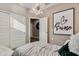 Well-lit bedroom with light fixture, 'je t'aime' artwork, and closet space at 24047 W Cocopah St, Buckeye, AZ 85326