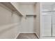 Walk-in closet with ample storage, shelving, and access to an enclosed walk-in shower at 24047 W Cocopah St, Buckeye, AZ 85326