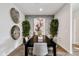 Elegant dining room with decorative wall art, hardwood floors, and stylish decor at 24047 W Cocopah St, Buckeye, AZ 85326