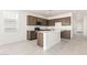 Well-lit kitchen features stainless appliances, a central island, and ample cabinet space at 24047 W Cocopah St, Buckeye, AZ 85326