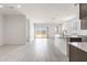 Spacious kitchen with island, modern appliances, and sliding glass door to the backyard at 24047 W Cocopah St, Buckeye, AZ 85326