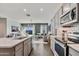 Bright, open kitchen with stainless steel appliances and views to the living area at 24047 W Cocopah St, Buckeye, AZ 85326