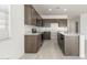 Modern kitchen with sleek cabinets, stainless steel appliances, and a spacious island at 24047 W Cocopah St, Buckeye, AZ 85326