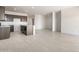 Open floor plan from the kitchen into the living area with light tile floors at 24047 W Cocopah St, Buckeye, AZ 85326