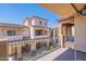 View from a condo balcony overlooking the exterior facade of neighboring buildings and blue skies at 2821 S Skyline Dr # 157, Mesa, AZ 85212