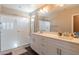Primary bathroom features a double vanity, a walk-in glass shower with a bench, and modern fixtures at 2821 S Skyline Dr # 157, Mesa, AZ 85212