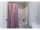 A full tub and shower combination with a pink shower curtain inside the bathroom at 2821 S Skyline Dr # 157, Mesa, AZ 85212