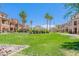 Expansive manicured green space with palm trees and multi-story buildings in a beautiful community at 2821 S Skyline Dr # 157, Mesa, AZ 85212