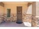 Inviting entrance featuring a decorative wreath, stone accents, and a well-maintained porch at 2821 S Skyline Dr # 157, Mesa, AZ 85212
