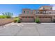 Exterior shot of townhomes with two car garages, desert landscaping and stone accents at 2821 S Skyline Dr # 157, Mesa, AZ 85212