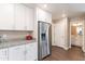 Bright kitchen with stainless steel refrigerator, granite countertops, and white cabinets at 2821 S Skyline Dr # 157, Mesa, AZ 85212