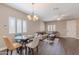 Open concept living room with modern decor, wood flooring, and plenty of natural light from large windows at 2821 S Skyline Dr # 157, Mesa, AZ 85212