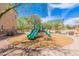 Community playground area featuring green slides, wood chip ground cover, and desert landscaping at 2821 S Skyline Dr # 157, Mesa, AZ 85212