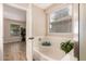 Bathroom with a white bathtub, a view into the bedroom, and a plant at 29161 N Lilly Ln, San Tan Valley, AZ 85143