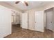 Bedroom featuring wood-look tile flooring with multiple doorways to other rooms at 29161 N Lilly Ln, San Tan Valley, AZ 85143