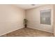 This bedroom offers neutral paint, a large window, and wood floors, ready for your personal touch at 29161 N Lilly Ln, San Tan Valley, AZ 85143
