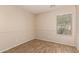 Empty bedroom featuring wood-look flooring and a large window for natural light at 29161 N Lilly Ln, San Tan Valley, AZ 85143