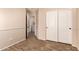 This bedroom features neutral paint, wood floors, a double door closet, and easy access to the laundry room at 29161 N Lilly Ln, San Tan Valley, AZ 85143