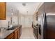 Modern kitchen featuring stainless steel appliances, tiled floors, and plenty of counter space for cooking at 29161 N Lilly Ln, San Tan Valley, AZ 85143