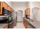 Well-equipped kitchen with wood cabinetry, stainless steel appliances, and tiled flooring at 29161 N Lilly Ln, San Tan Valley, AZ 85143
