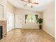 Spacious living room with stone fireplace, wood-look floors, and plenty of natural light at 29161 N Lilly Ln, San Tan Valley, AZ 85143