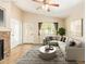 Comfortable living room with stylish furniture, a stone fireplace and ample natural light at 29161 N Lilly Ln, San Tan Valley, AZ 85143