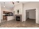 Open-concept living room with a stone fireplace, hardwood floors, and seamlessly connecting to the kitchen at 29161 N Lilly Ln, San Tan Valley, AZ 85143