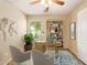 Staged home office features a bookshelf and a comfortable seating area. A leafy green plant adds color at 29161 N Lilly Ln, San Tan Valley, AZ 85143