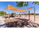 Community playground with shade structure, swings, and slides offering a fun recreational space at 29161 N Lilly Ln, San Tan Valley, AZ 85143