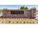 Stone sign for Indigo Sky Recreation Center surrounded by colorful flowerbeds at 29161 N Lilly Ln, San Tan Valley, AZ 85143