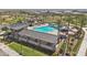 Aerial view of a community pool featuring shade structures, playground, lounge chairs, and desert landscaping at 2953 E Mecklenburg Way, San Tan Valley, AZ 85143