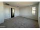 A bright bedroom featuring neutral carpet, natural light, and ample closet space at 3013 E Mecklenburg Way, San Tan Valley, AZ 85143