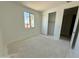 Bright bedroom with closet and natural light from a window, featuring smooth walls and trim waiting for personal touches at 3013 E Mecklenburg Way, San Tan Valley, AZ 85143