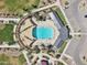 Aerial view of community pool with ramada, lounge chairs, and palm tree landscaping at 3013 E Mecklenburg Way, San Tan Valley, AZ 85143