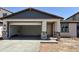 Charming single-Gathering home featuring a two-car garage and covered porch with stone pillars at 3013 E Mecklenburg Way, San Tan Valley, AZ 85143