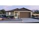 Charming single-story home with a two-car garage, neutral colors, stone accents and desert landscaping at 3013 E Mecklenburg Way, San Tan Valley, AZ 85143