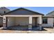 A charming single-story home featuring a spacious two-car garage and covered front entryway, bathed in natural light at 3013 E Mecklenburg Way, San Tan Valley, AZ 85143