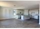 Open floor plan kitchen featuring white cabinets, island, and modern backsplash, all overlooking a spacious living area at 3013 E Mecklenburg Way, San Tan Valley, AZ 85143