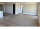 Spacious living room area that showcases wood-look floors and natural light from the windows at 3013 E Mecklenburg Way, San Tan Valley, AZ 85143