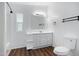 Bright bathroom with a toilet, white cabinets, updated lighting and a large mirror at 320 E Mckellips Rd # 163, Mesa, AZ 85201