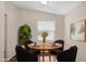 Another view of the dining area with a round table, seating for four, and a large house plant at 320 E Mckellips Rd # 163, Mesa, AZ 85201
