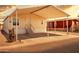 This home's exterior features a covered carport and desert landscaping at 320 E Mckellips Rd # 163, Mesa, AZ 85201