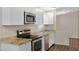Close-up of a kitchen featuring granite counters and stainless steel appliances at 320 E Mckellips Rd # 163, Mesa, AZ 85201