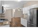 Spacious kitchen with stainless steel refrigerator, white cabinets, and open layout to the living area at 320 E Mckellips Rd # 163, Mesa, AZ 85201