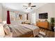 Serene main bedroom featuring a ceiling fan, TV and calming decor at 320 E Mckellips Rd # 163, Mesa, AZ 85201