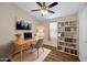 This home office features a wooden desk, ceiling fan, and hardwood floors at 320 E Mckellips Rd # 163, Mesa, AZ 85201