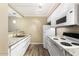 Well-lit kitchen with white cabinetry, modern appliances, and granite countertops at 3314 N 68Th St # W112, Scottsdale, AZ 85251