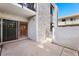 Relax on this home's private patio featuring neutral concrete flooring and stucco walls with a sliding glass door at 3314 N 68Th St # W112, Scottsdale, AZ 85251