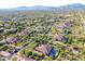A wide shot of homes nestled in a desert landscape against a scenic mountain backdrop at 35443 N 87Th Pl, Scottsdale, AZ 85266